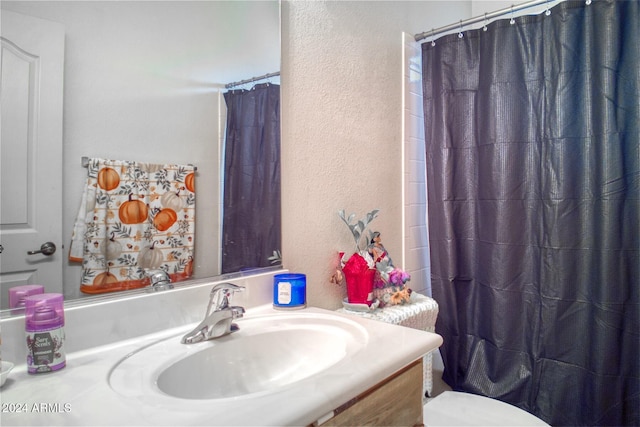 bathroom with vanity, toilet, and a shower with shower curtain