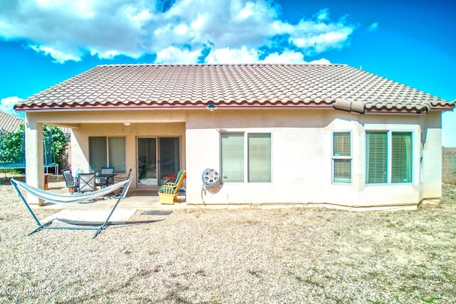 rear view of property featuring a patio