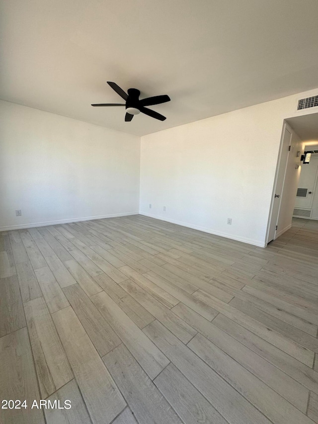 spare room featuring ceiling fan and light wood-type flooring