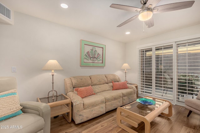 living room featuring ceiling fan and light hardwood / wood-style flooring