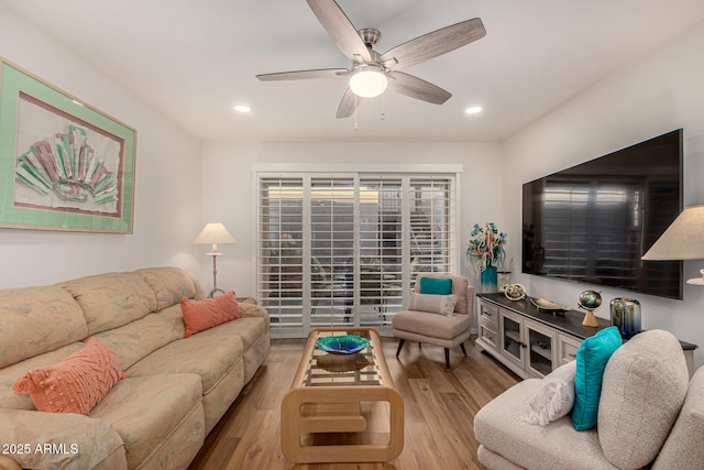 living room with ceiling fan and light hardwood / wood-style floors