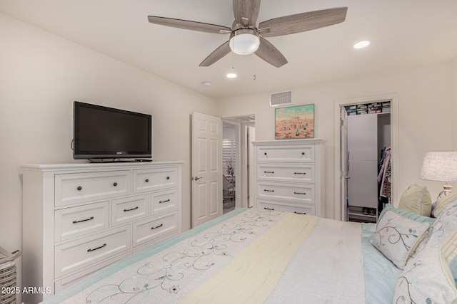 bedroom featuring a spacious closet and ceiling fan