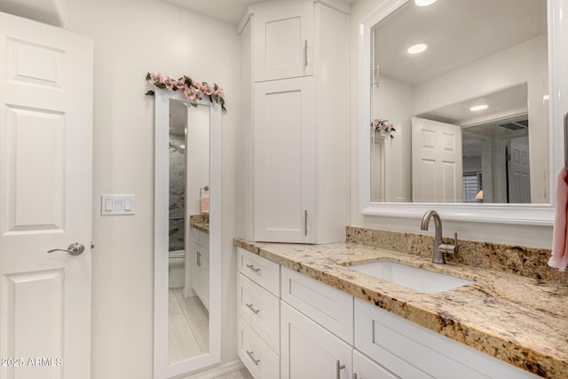 bathroom featuring tile patterned floors, toilet, and vanity