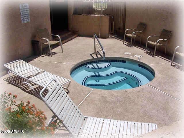 view of swimming pool with a patio and a community hot tub