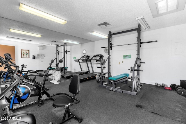 exercise room with a textured ceiling