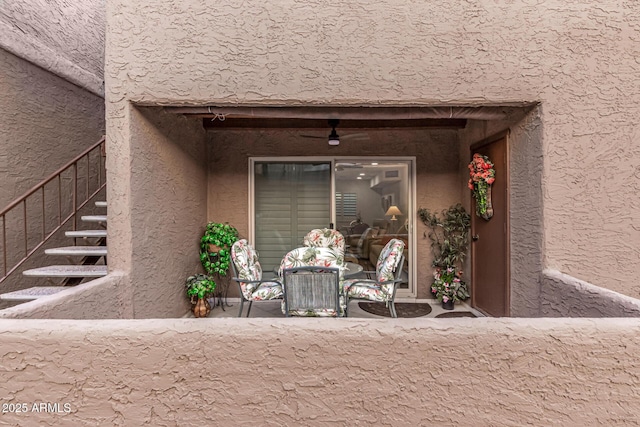 doorway to property with ceiling fan