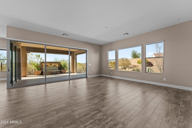 empty room with hardwood / wood-style flooring