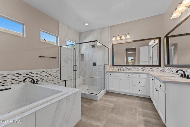 bathroom with tile patterned flooring, vanity, and plus walk in shower