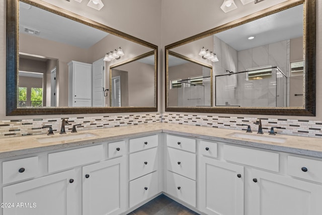 bathroom featuring vanity, an enclosed shower, and backsplash