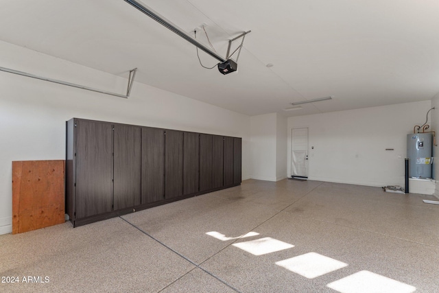 garage with electric water heater and a garage door opener