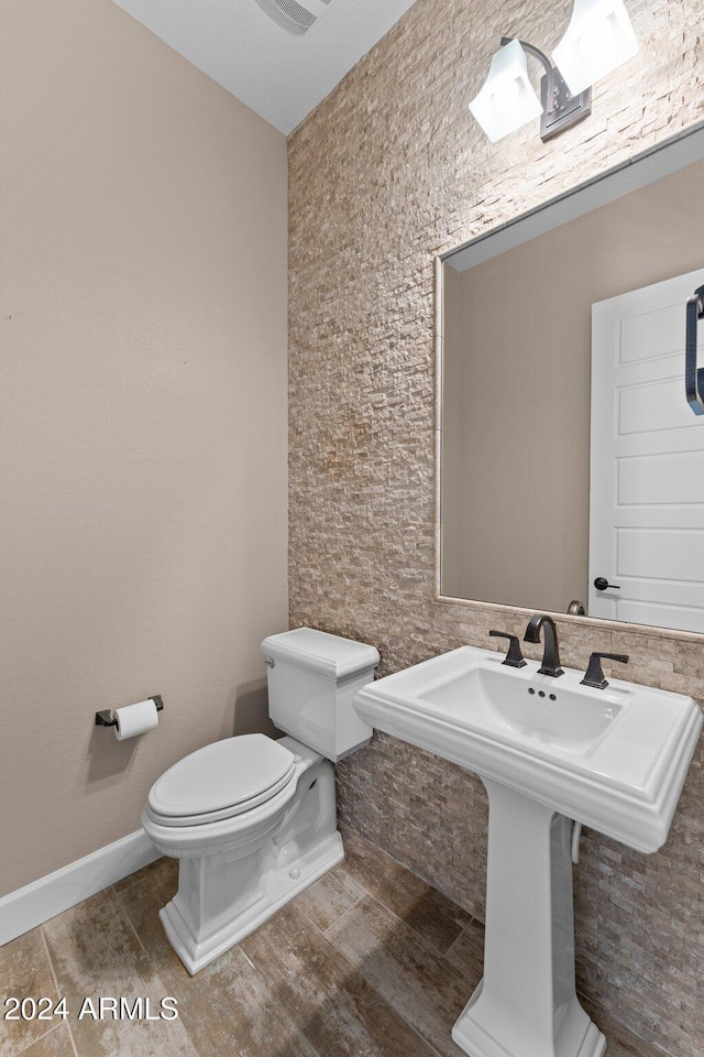 bathroom featuring sink and toilet