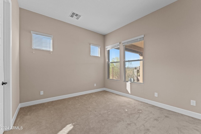 unfurnished room featuring light colored carpet