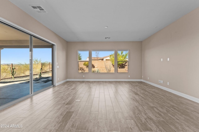 empty room with a healthy amount of sunlight and light wood-type flooring