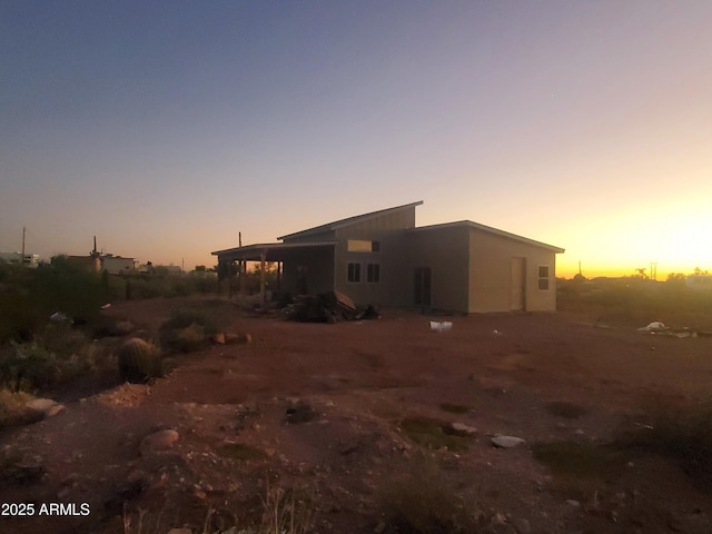 view of back of house at dusk