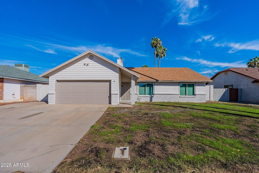 ranch-style house with a garage and a front yard