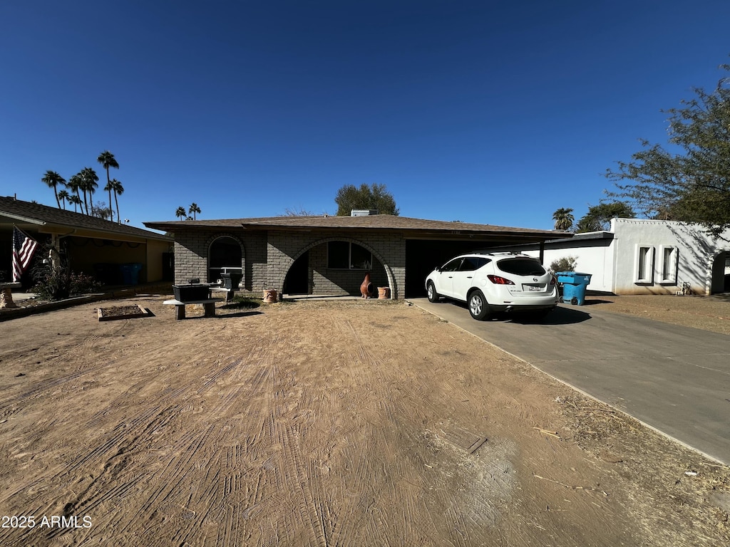 ranch-style home featuring a carport