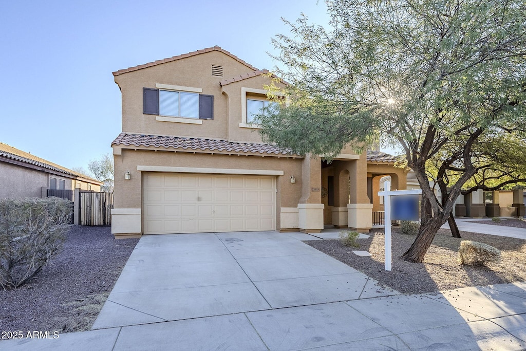 mediterranean / spanish home with a garage