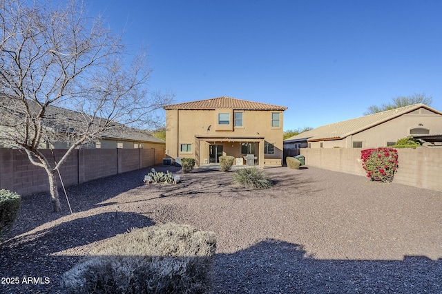 back of property with a patio