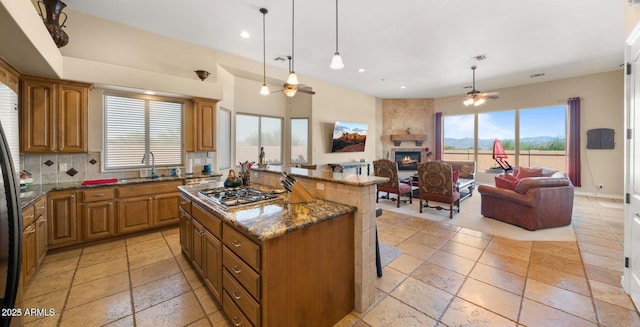 28309 N 156th Way, Scottsdale, AZ 85262 - kitchen featuring a ceiling fan, appliances with stainless steel finishes, open floor plan, a large fireplace, and a sink