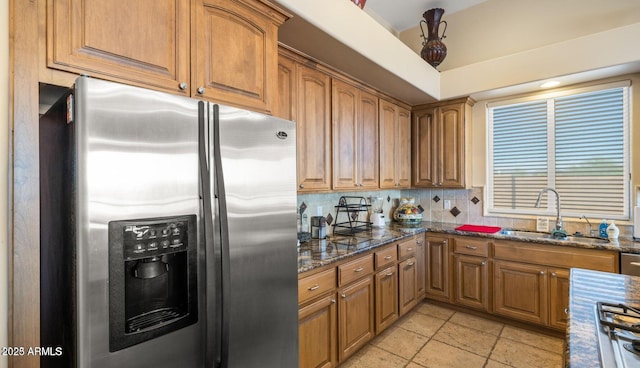 28309 N 156th Way, Scottsdale, AZ 85262 - kitchen with stainless steel refrigerator with ice dispenser, a sink, backsplash, dark stone countertops, and brown cabinets