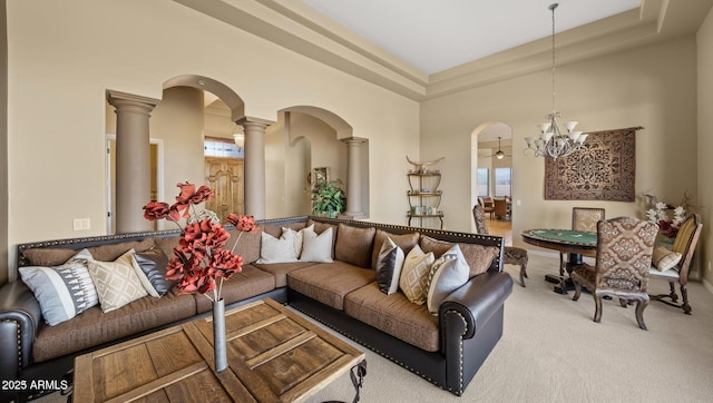28309 N 156th Way, Scottsdale, AZ 85262 - living room with arched walkways, ornate columns, a chandelier, carpet flooring, and a high ceiling