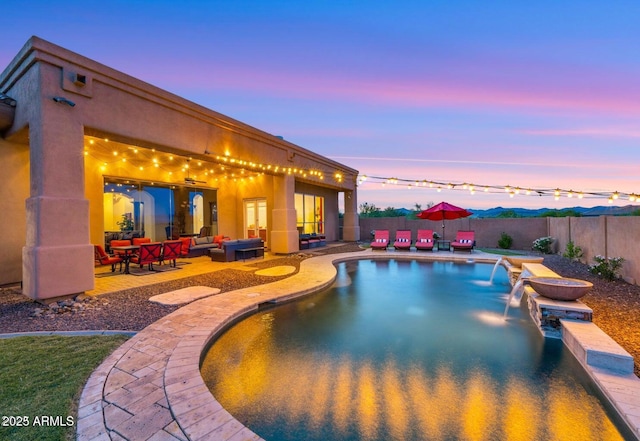28309 N 156th Way, Scottsdale, AZ 85262 - pool at dusk with an outdoor living space, a patio, and a fenced backyard