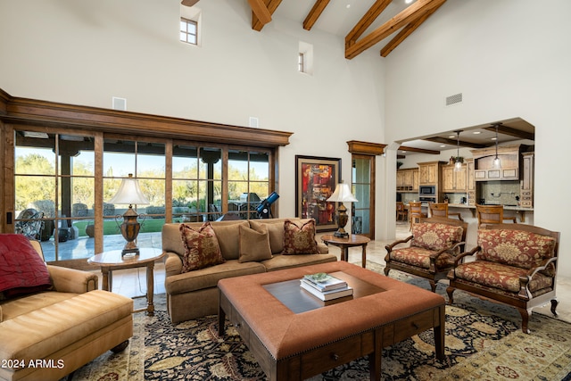 living room with high vaulted ceiling, a wealth of natural light, and beamed ceiling