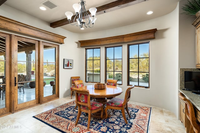 dining space featuring beam ceiling and a chandelier