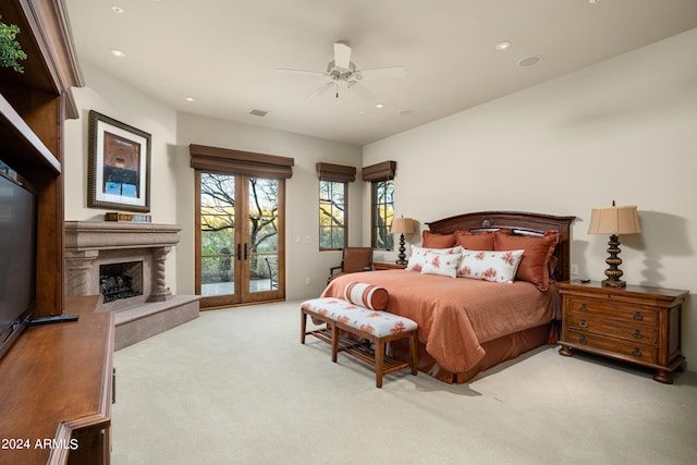 bedroom featuring light carpet, ceiling fan, access to outside, and french doors