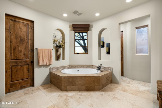 bathroom with tiled tub