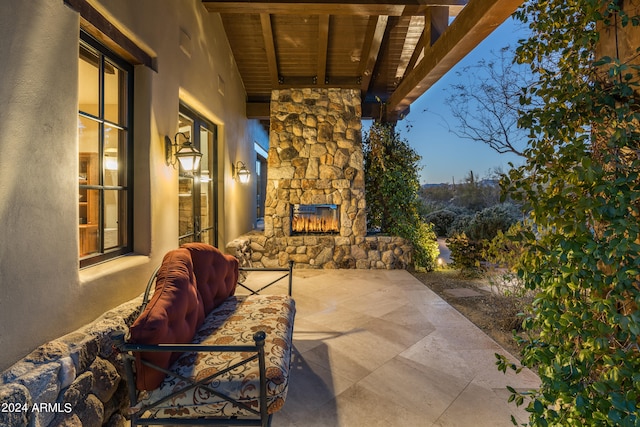 view of patio / terrace featuring an outdoor stone fireplace