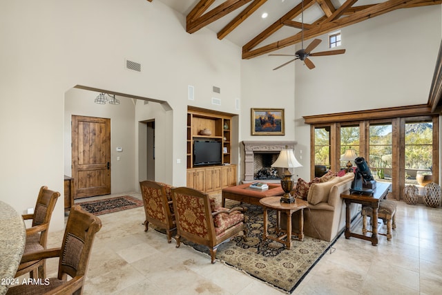 living room featuring ceiling fan, beam ceiling, and high vaulted ceiling