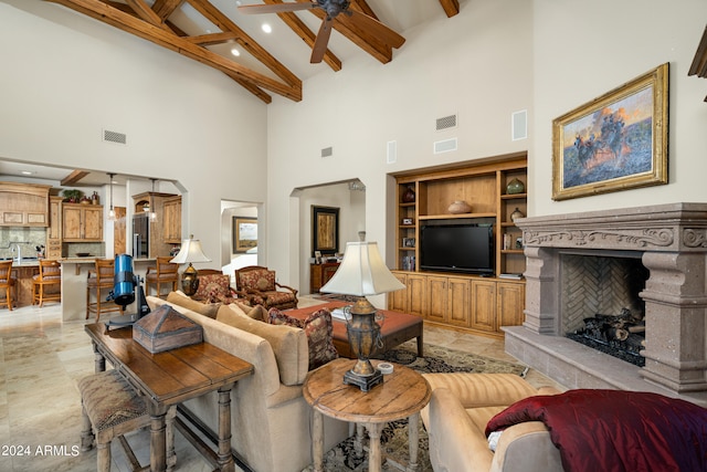 living room featuring ceiling fan, beam ceiling, and high vaulted ceiling