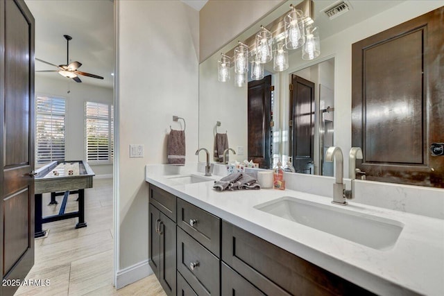 full bathroom with a sink, visible vents, ceiling fan, and double vanity