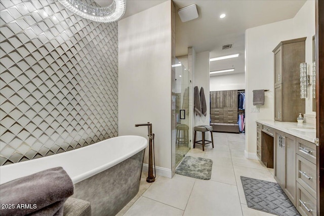 full bathroom featuring visible vents, a shower stall, a freestanding bath, tile patterned floors, and vanity