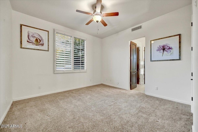 empty room featuring visible vents, baseboards, carpet, and a ceiling fan