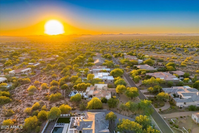 aerial view at dusk featuring a residential view