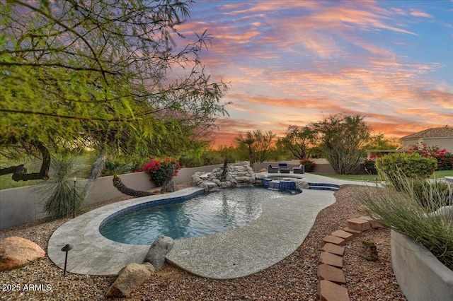 view of pool with a patio, a pool with connected hot tub, and a fenced backyard