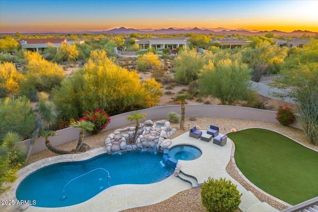 view of swimming pool with a mountain view, a patio, an in ground hot tub, and a fenced backyard