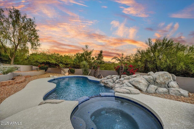 view of swimming pool with a pool with connected hot tub