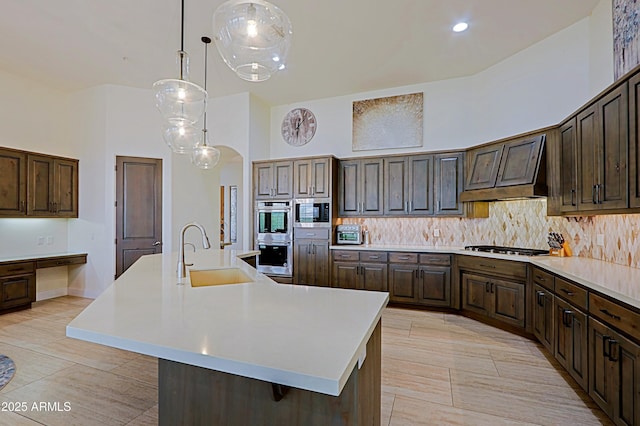 kitchen with tasteful backsplash, a towering ceiling, and a sink