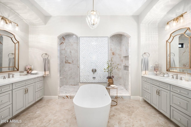 bathroom featuring shower with separate bathtub, vanity, and a notable chandelier