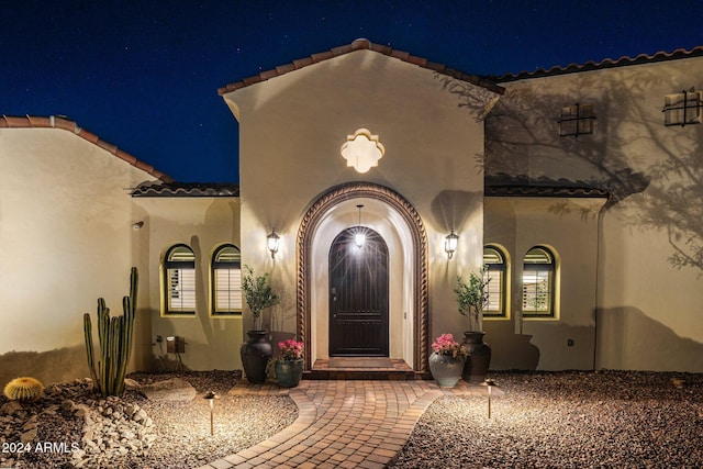 view of exterior entry at night