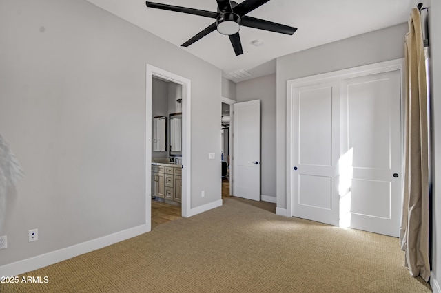 unfurnished bedroom with visible vents, baseboards, connected bathroom, light colored carpet, and a closet