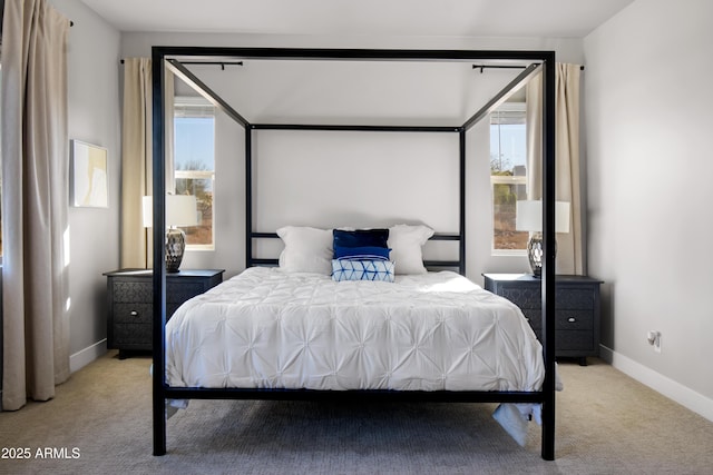 bedroom featuring carpet and baseboards