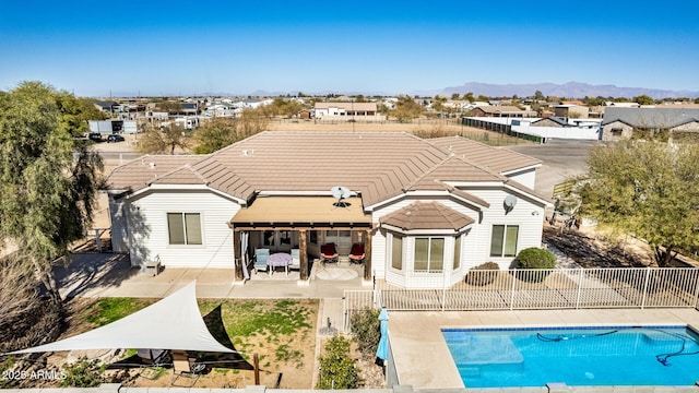 rear view of house with a mountain view and a patio area