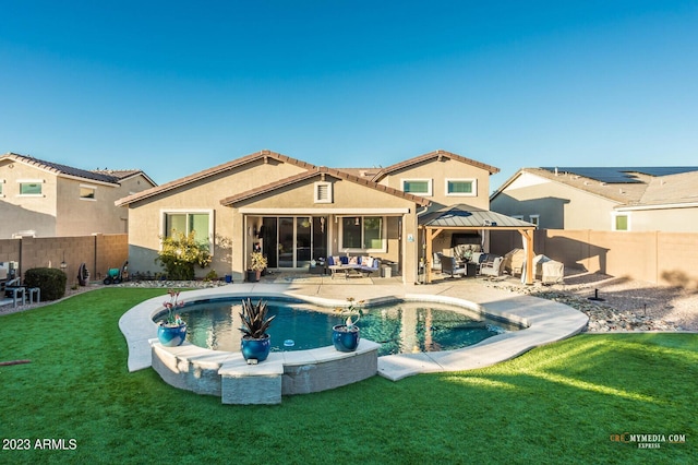 back of house with a patio area, stucco siding, outdoor lounge area, a fenced backyard, and a lawn