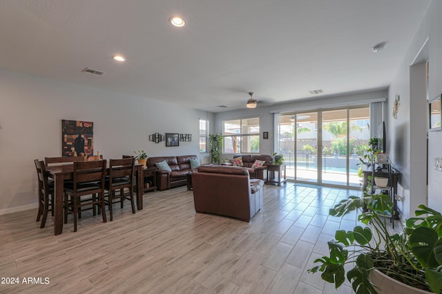 living room featuring a wealth of natural light and ceiling fan