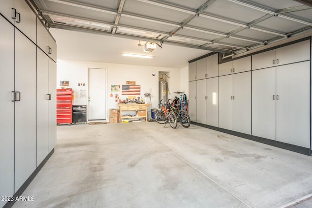 garage with water heater and a garage door opener