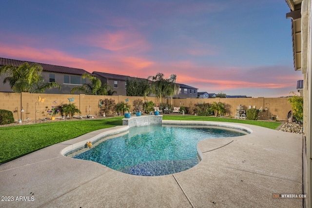 pool at dusk with a patio area and a yard